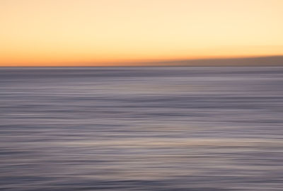 Scenic view of sea against clear sky during sunset