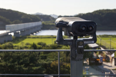 Coin-operated binoculars on observation point against imjin river