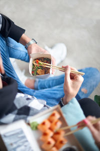 Midsection of woman holding food on table