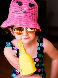 Close-up portrait of smiling girl wearing sunglasses
