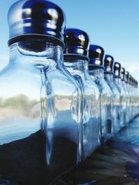 Close-up of glass bottles arranged on table