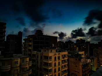 High angle view of buildings in city at night