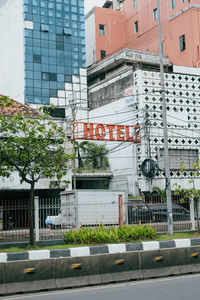 Road sign on street by buildings in city