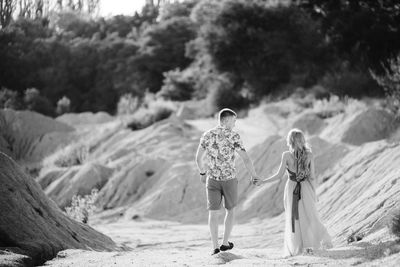 Rear view of couple walking on land
