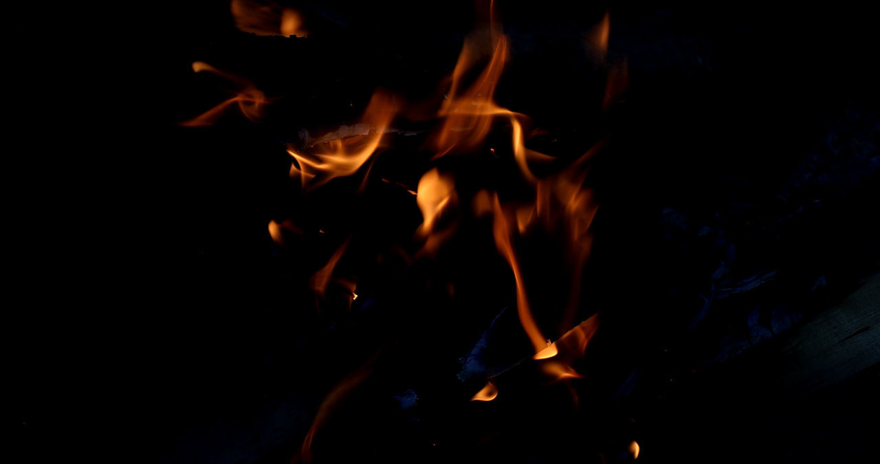 CLOSE-UP OF FIRE IN DARK