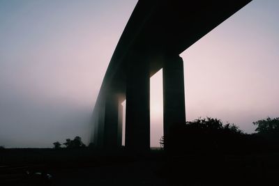 Low angle view of silhouette building against sky
