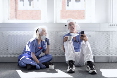 Doctors wearing personal protective equipment at coffee break