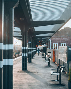 Man walking on road amidst buildings in city