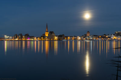 Reflection of illuminated buildings in water at night