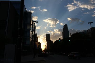 Modern buildings against cloudy sky