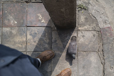 Low section of man standing on footpath