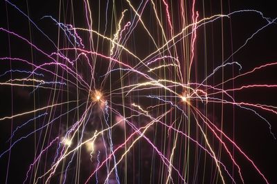 Low angle view of firework display at night