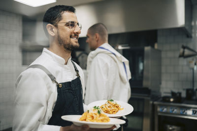 Side view of man preparing food in kitchen