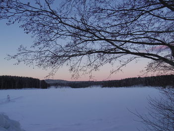 Scenic view of lake against sky during winter