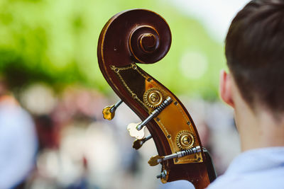 Rear view of a man on with cello