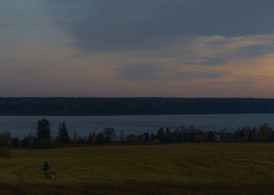 Scenic view of field against sky during sunset