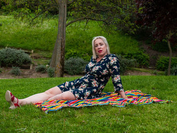 Portrait of woman sitting on grass