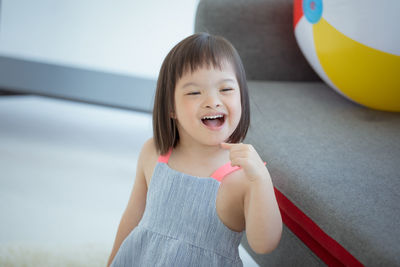 Close-up of cute girl smiling at home