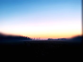 Scenic view of silhouette landscape against clear sky during sunset