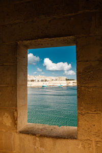 Scenic view of sea against sky seen through window