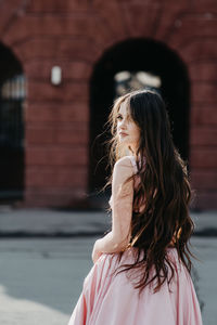 Young woman standing against blurred background