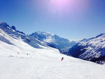 People skiing on snow covered landscape