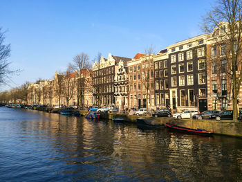 Boats in canal with buildings in background