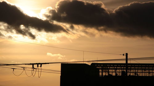 Low angle view of silhouette bridge against sky during sunset