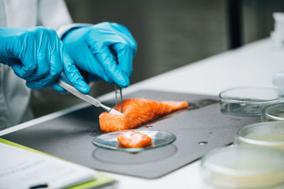 Food safety and quality testing salmon fish. laboratory technician taking salmon fish sample.