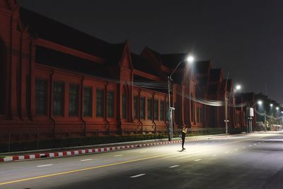 View of illuminated road at night