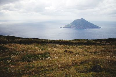 Scenic view of sea against cloudy sky