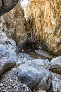 Rear view of man standing on rocks