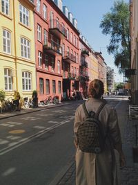 Woman walking on road in city