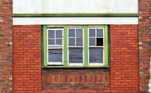 Full frame shot of window on brick wall of building