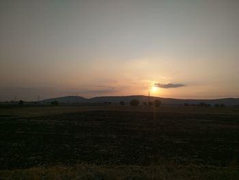 Scenic view of field against sky during sunset