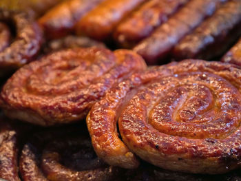 Close-up of sausages and meat on barbecue grill