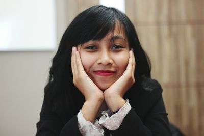 Close-up portrait of smiling young woman