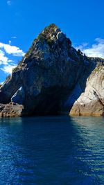 Scenic view of rock formation in sea against sky