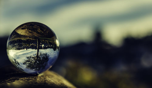 Close-up of crystal ball against blurred background