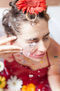 High angle view of woman bathing with flowers