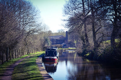 Boats in canal against sky