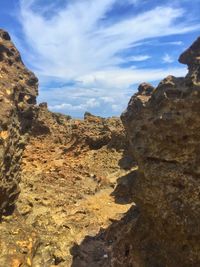 Low angle view of rock formations against sky