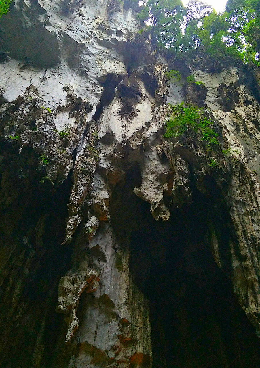 LOW ANGLE VIEW OF ROCK FORMATIONS IN CAVE