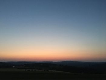 Scenic view of silhouette landscape against clear sky during sunset