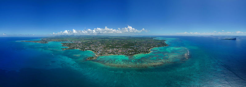 Panoramic view of sea against blue sky