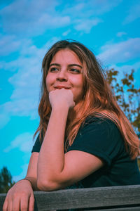 Portrait of smiling woman sitting outdoors