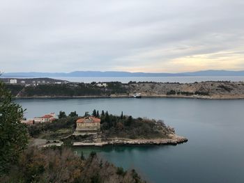 Panoramic view of lake by buildings against sky