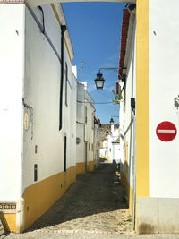 Street amidst buildings against sky