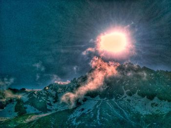 Scenic view of sea against mountain during sunset