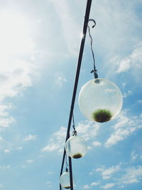 Low angle view of street light against cloudy sky